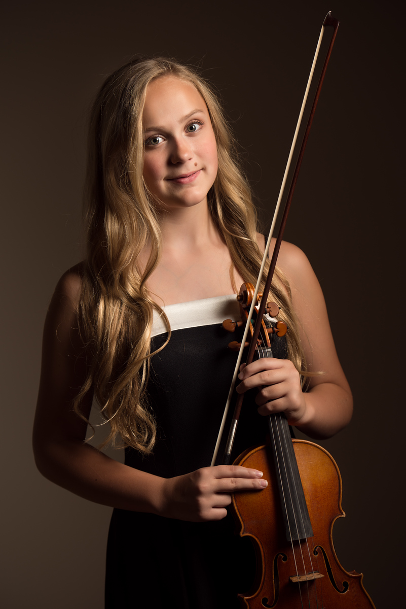 Three cheerleaders in blue and gold M uniforms in a stacked pose, Spokane studio photography session