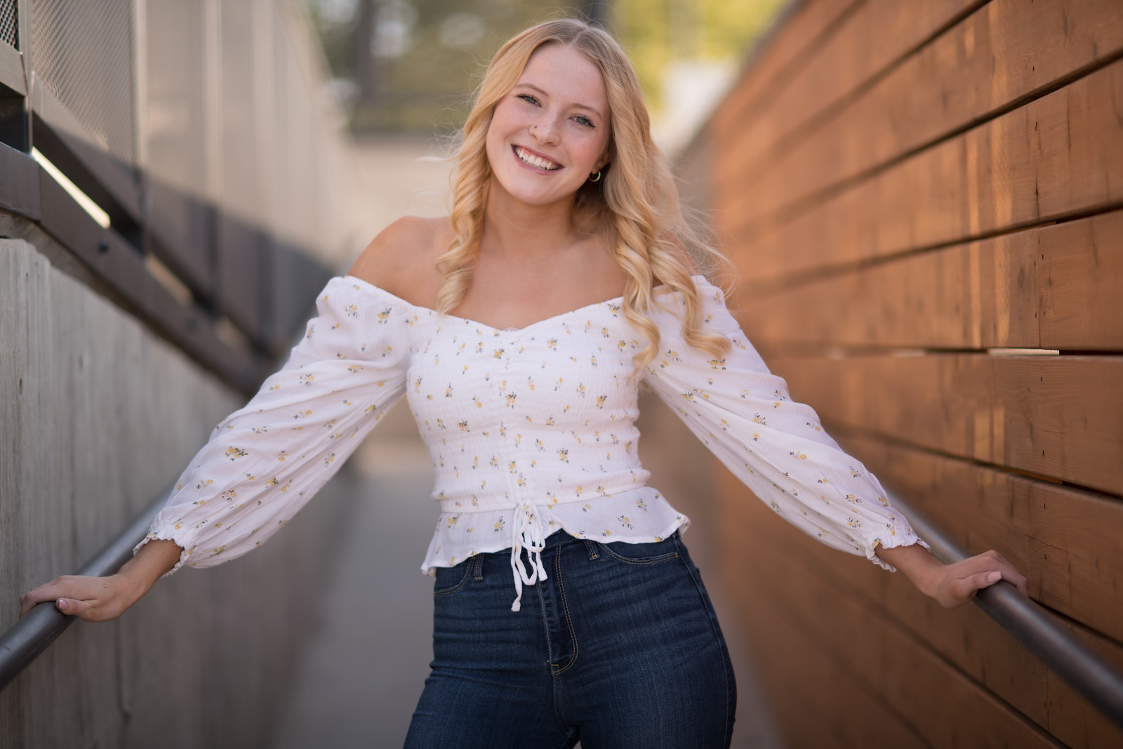 Woman in white button-up shirt with blonde bob, outdoor portrait with green bokeh background, Spokane photography